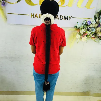 A classic South Indian bridal braid, showcasing a neat, extra-long style finished with traditional gajra and hair jewelry. We cover how to use hair extensions to achieve this dramatic length.