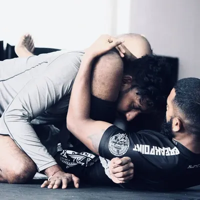 A great shot from a BJJ rolling session. This shows the intensity and focus required in grappling. We constantly work on winning these small moments, improving our position, and looking for the submission.