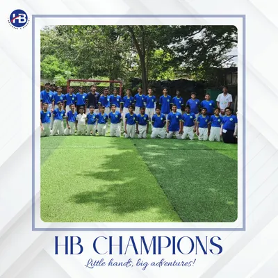 This is where greatness begins. A team of HB Champions kneels on the turf, representing the discipline and unity forged during our training sessions.