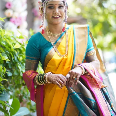 A full-length view of a bride in a yellow Nauvari saree, ready for her Vidhi ceremony. My service includes professional saree draping that is both beautiful and comfortable.