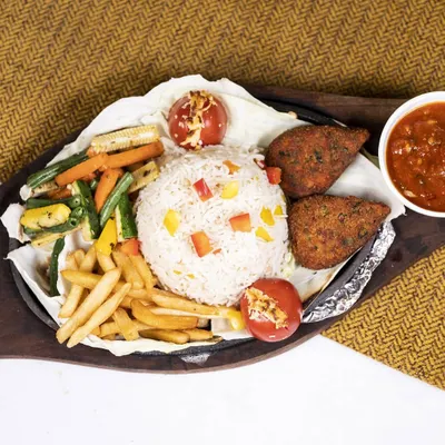Our Veg Sizzler is a complete meal, loaded with your favorites. It includes crispy cutlets, seasoned rice, french fries, and assorted grilled vegetables, all served on a piping hot plate.