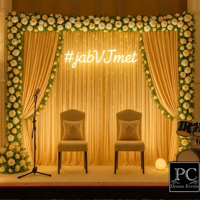 A modern and chic engagement stage. I used a personalized neon hashtag '#jabVJmet' as the centerpiece, against a backdrop of warm yellow drapes and a frame of white roses.