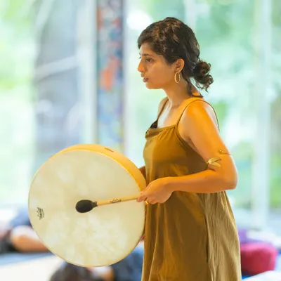 Using a frame drum during a sound healing session. The deep, resonant vibrations of the drum can be incredibly grounding, helping to bring you fully into the present moment.