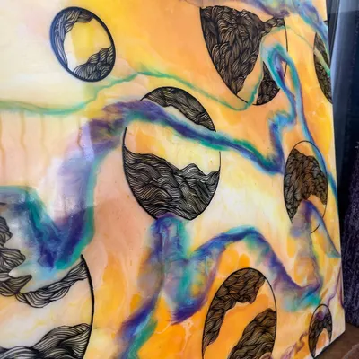 A closer look at my mixed-media work. The vibrant, fluid colors of the resin create a beautiful background for the detailed, hand-drawn doodle patterns inside each circle.