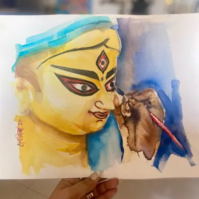 A watercolor painting depicting "Chokkhu Daan," the sacred moment when the eyes are painted onto the idol of Ma Durga, signifying the beginning of her journey home for Durga Puja.
