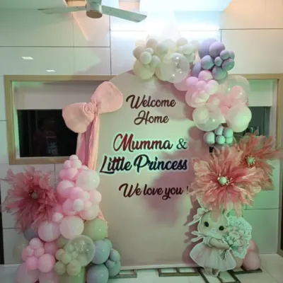 A sweet and simple welcome home setup for a little princess. This decoration features a pastel balloon garland, a cute bunny prop, and a personalized backdrop, perfect for a cozy corner in your home.