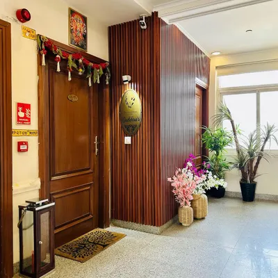 A welcoming entryway at a Central Park Resort residence. I used fluted wood paneling to add texture and warmth, while the plants and traditional door hangings create an inviting first impression.