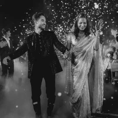 A grand entrance sets the tone for the night. I captured this couple walking through a cloud of smoke, a moment filled with drama and excitement. My goal is to make your wedding film feel as energetic as the celebration itself.