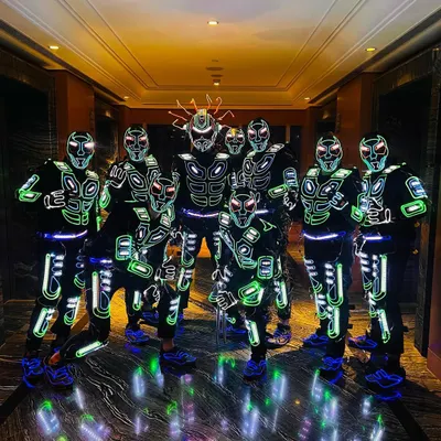 Our full crew assembled in our latest generation of robotic Tron suits. The detail in these costumes, with their glowing green and white patterns, is designed for maximum visual impact on stage.