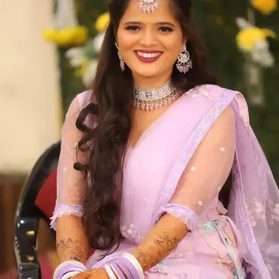 A stunning Sangeet look in a pastel lavender lehenga. The makeup is glamorous with a bold lip and sparkling diamond jewelry, perfect for a night of dancing.