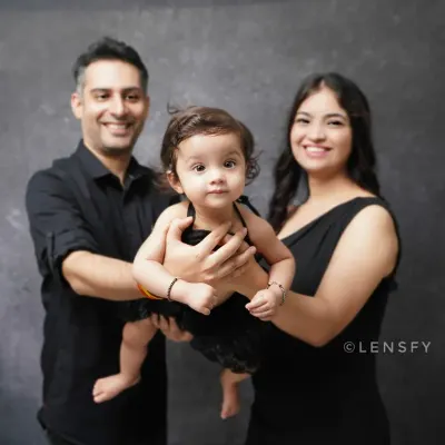 A classic and elegant family portrait. The coordinated black outfits create a timeless look against a simple studio backdrop, putting all the focus on your family's connection.