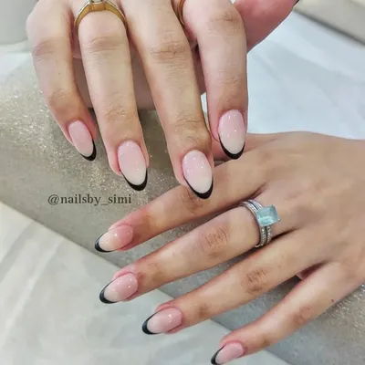 A modern classic. These deep curve black French tips on a natural nude base are so chic and sophisticated.