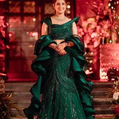 A bride glowing in a magnificent emerald green sculpted gown by Gaurav Gupta for her cocktail night. My styling focused on the dramatic ruffles and sparkling details of the dress.