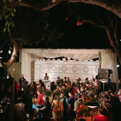 A wide view of the Sufi-themed Mehfil-e-Mehendi. The entire space was designed for an immersive musical experience, with a central stage and comfortable seating for guests to enjoy the performances.