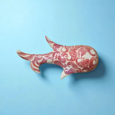 This fish wall sculpture, hand-painted in red, is a timeless symbol of wealth, fertility, and good fortune. It represents life's continuous flow and the promise of abundance.