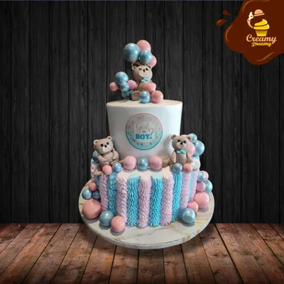 Is it a girl or a boy? This two-tier gender reveal cake is decorated with pink and blue stripes, balloons, and cute teddy bears, building excitement for the big reveal.