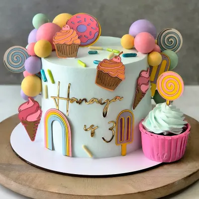 Welcome to Candyland! This 1.5kg Chocolate Mousse cake is a burst of colour, decorated with lollipops, donuts, and cupcakes to match the party's theme.