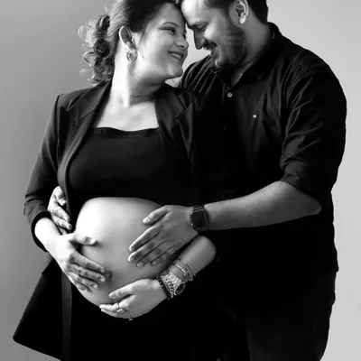 A classic black and white portrait that’s full of love. The couple’s happy expressions and the way they hold the baby bump together make this a truly heartwarming and timeless image.