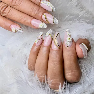 An exquisite bridal design featuring almond-shaped extensions with a soft pink base, white French tips, and intricate 3D floral and gold wire details.