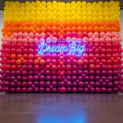 A branded photo wall is essential for modern corporate events. Here, I combined a vibrant, multi-tonal balloon wall with a custom neon sign to create an engaging backdrop that encourages social sharing and reinforces the event's theme.