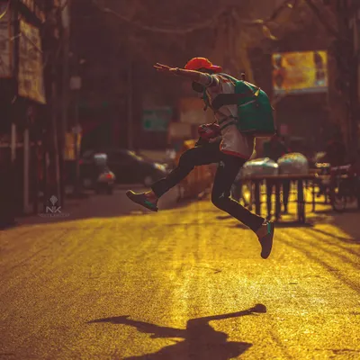 An action portrait in the backstreets of Agra. The jump, the low angle, and the warm evening light all come together for a 'kadak' shot that's full of life.