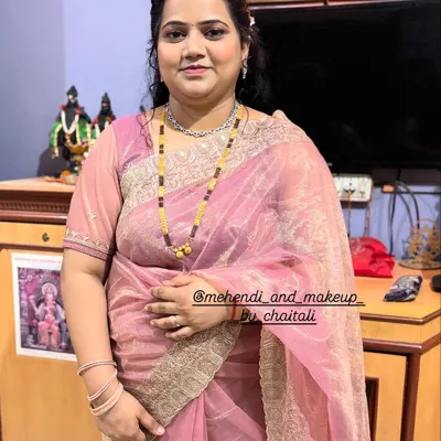 A full-length view of a party-ready look. This client wanted soft, nude makeup with a simple hairstyle and saree draping for a family function.