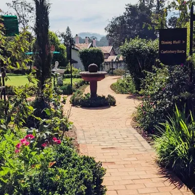 We had the privilege of redesigning the landscape for the historic Taj Savoy hotel in Ooty. This brick pathway leads through a classic English-style garden with a central fountain.