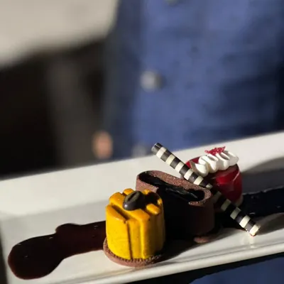 Dessert should be a work of art. This plated trio, featuring chocolate, fruit, and coffee elements, is designed for a sophisticated sit-down dinner where every course is a statement.