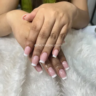 A beautifully executed classic French manicure on square-shaped extensions. The lines are clean, and the natural pink base gives it a very polished and sophisticated look.