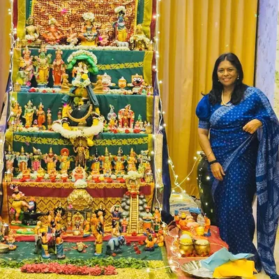 Celebrating the Dasara doll festival in a beautiful royal blue bandhani saree. The vibrant colors of the dolls and the saree reflect the deep traditions of Navratri.