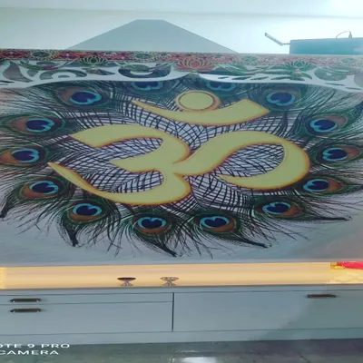 A custom printed roller blind I created for a puja room, featuring an 'Om' symbol with peacock feathers. If you have a specific design or image in mind, I can print it on a blind for you.