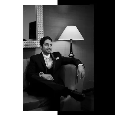 A classic black and white portrait of the groom, Wazir, looking relaxed and happy.