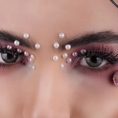 This is where beauty and art meet. I used macro techniques to capture the delicate details of the makeup, from the individual pearls to the texture of the flower petals, creating a powerful image for this beauty product campaign.