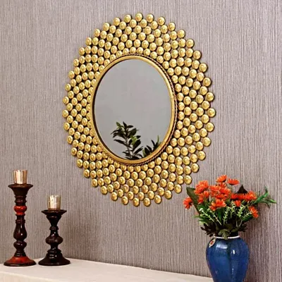 This antique golden finish metallic round wall mirror is framed by a burst of small, textured discs. The design is both playful and elegant, creating a beautiful focal point above a console table or fireplace. Size customization is available.