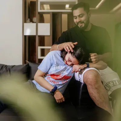 A genuinely happy and relaxed moment during an at-home photoshoot, capturing pure laughter.