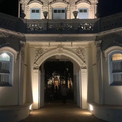 The main archway of Rhodesia House, illuminated at night. We carefully restored the ornate plasterwork and architectural details to highlight the building's unique character, creating a welcoming beacon for the Dharmaj community.
