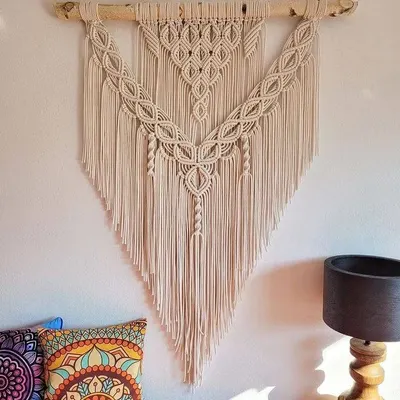 This large, V-shaped macrame wall hanging is one of my signature bohemian pieces. It's shown here in a living room, adding a beautiful, natural texture above the sofa.