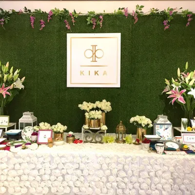 The main product display for a KIKA Tableware trunk show, designed to be the focal point of the event. I built a custom hedge wall as a natural backdrop for the brand's logo and arranged their products amidst lush floral arrangements to highlight their quality and design.