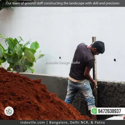 My team is the backbone of my work. Here, a member of my ground staff is preparing the foundation for a new landscape project, showing the hands-on effort that goes into every build.