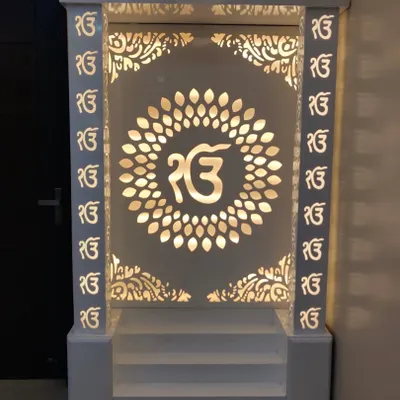 A beautifully crafted mandir we designed, finished in white with intricate 'Ek Onkar' jali work. The backlighting creates a serene and divine ambiance.