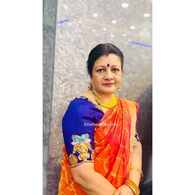 A beautiful client showcasing her custom blouse featuring a hand-painted Tanjore art motif on the sleeve. This unique detail adds a personal and artistic touch to her traditional silk saree ensemble.