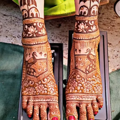 Bridal feet mehndi featuring majestic peacocks and cute little elephants. The design covers the entire foot, creating a look that is as intricate and beautiful as the mehndi on the hands.