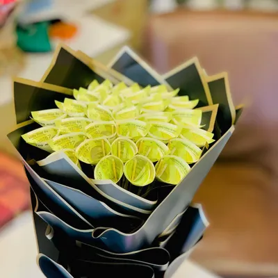This is a unique and impressive money bouquet made from Indian currency notes. I fold each note into a petal shape and arrange them into a flower, then wrap the entire bouquet in a dramatic, multi-layered black Korean-style wrap.