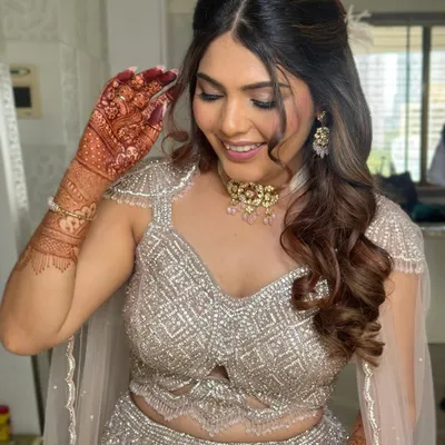 For this glamorous engagement look, I styled the hair in a voluminous half-up style with cascading curls. This hairstyle pairs beautifully with heavily embellished outfits.