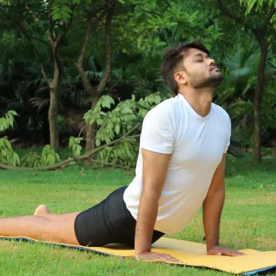 Bhujangasana (Cobra Pose) is a gentle backbend that strengthens the spine and opens the chest. It's a key part of the Surya Namaskar sequence and is wonderful for improving posture and breathing capacity.