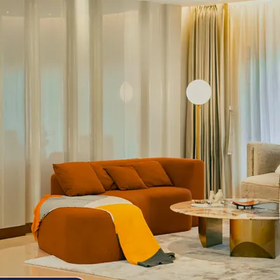 In the living room of my Guwahati project, I used a combination of soft curtain-filtered natural light and a modern globe floor lamp. This shows my process from blueprint to brilliance, creating a warm and inviting atmosphere.