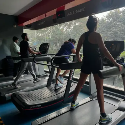 A view of the cardio section with several members on the treadmills. The atmosphere is focused and energetic.