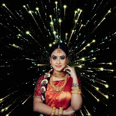 A stunning bridal portrait using a creative firework lighting effect. The bride stands confidently as the light bursts around her, symbolizing a celebration of her new beginning.