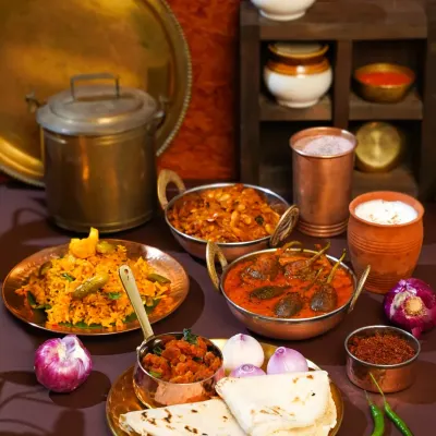 A tribute to the heart of Maharashtra. This spread, inspired by my travels in Ratnagiri, features authentic dishes like Bharli Vangi and Bhakri, styled with traditional brass and copper utensils to recreate the soul of a village kitchen.