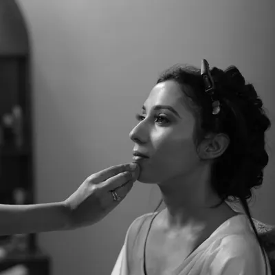 A quiet moment of focus. This black and white shot captures the artistry and precision that goes into every makeup application. We teach our students to approach their work with the focus of a true artist.